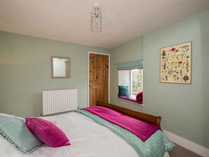 Pretty bedroom with large bed | The Coach House, Fremington, near Richmond