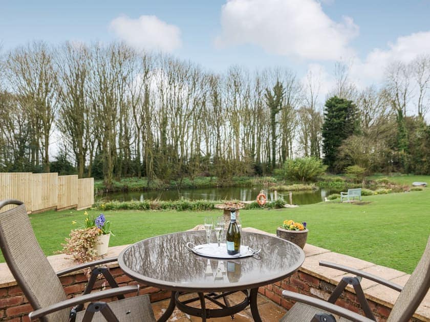 Sitting out area with lovely views | Liliy Pad Lodge - Garden House Cottages, Market Stainton, near Market Rasen