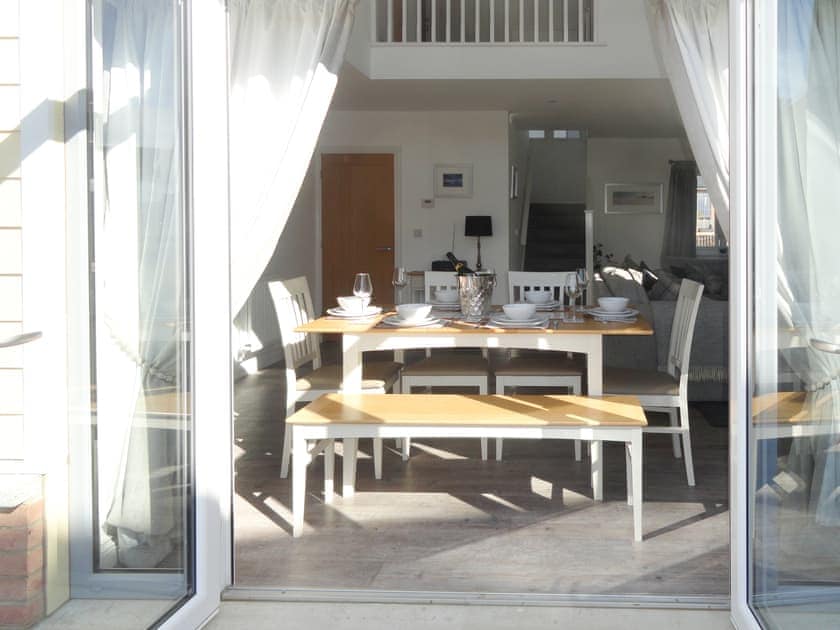 Stunning dining area with French doors to patio | Dune View, Beadnell, near Alnwick