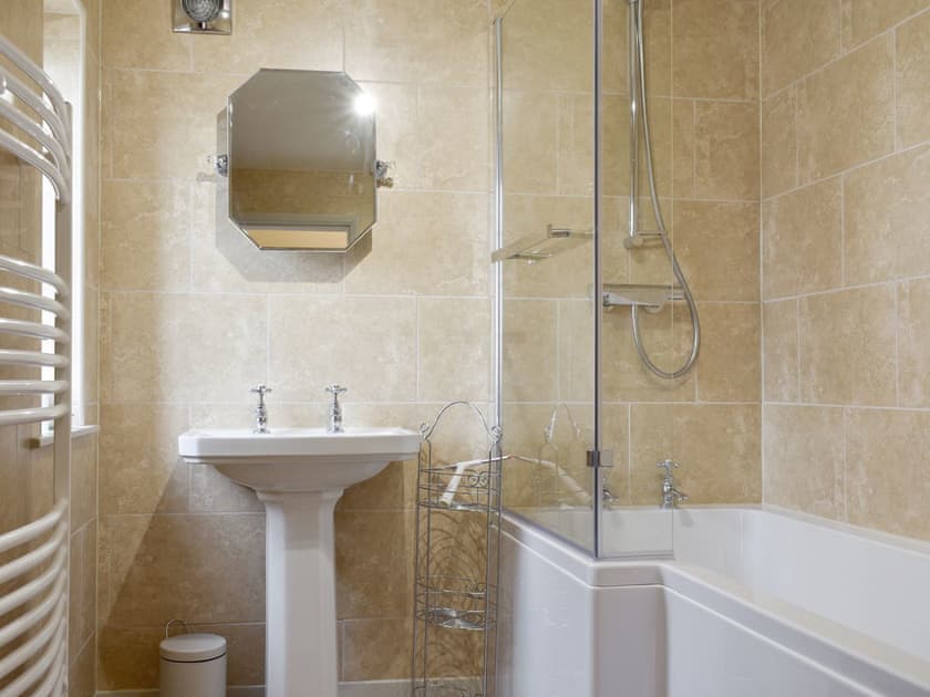 Family bathroom with shower over bath | Manor House Cottage, Holme on Swale, near Thirsk