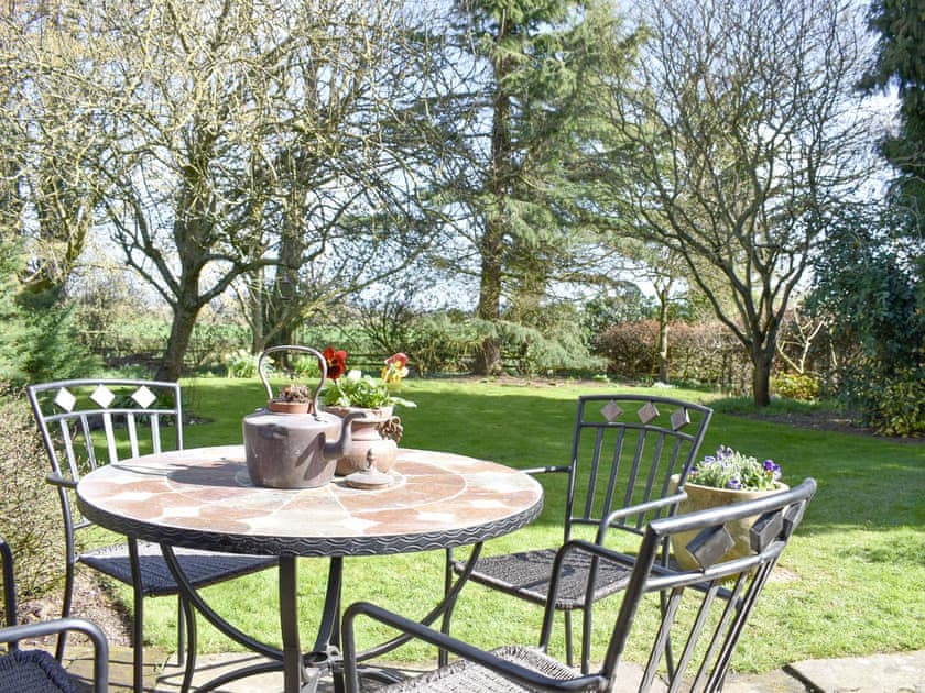 Patio area overlooking the lawned garden | Manor House Cottage, Holme on Swale, near Thirsk
