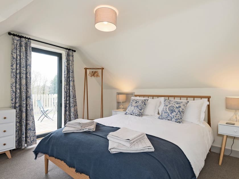 Tastefully furnished double bedroom with French door leading to balcony | Meadow View, North Walsham