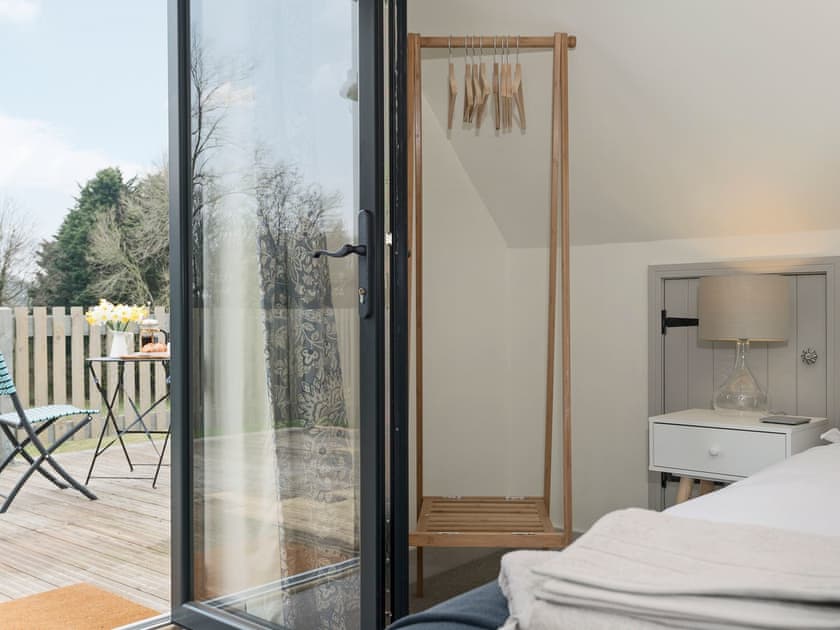 Tastefully furnished double bedroom with French door leading to balcony | Meadow View, North Walsham
