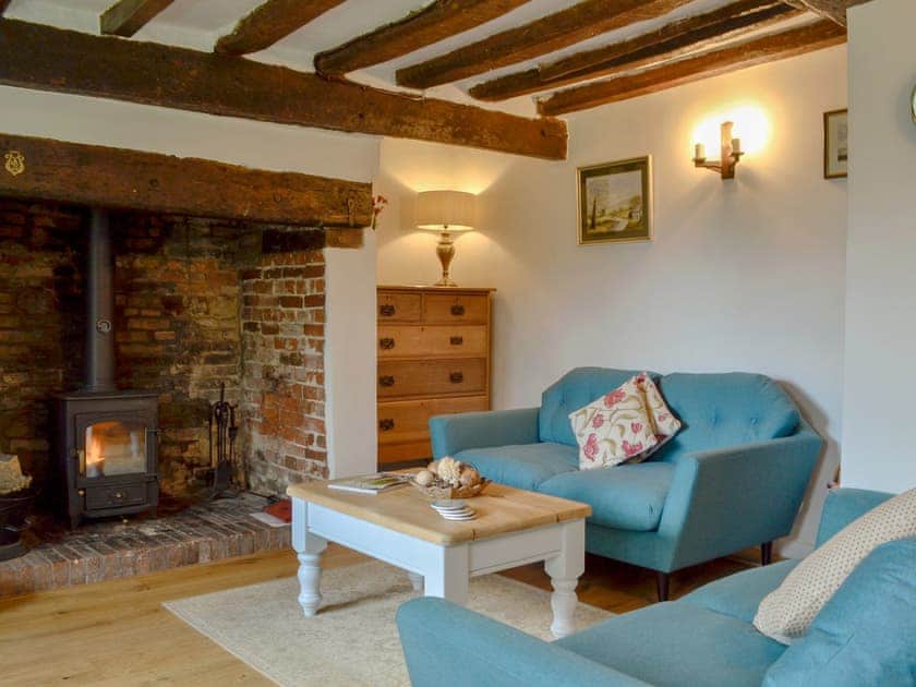 Comfortable living room with beamed ceiling | Three Ash Cottage, Bungay