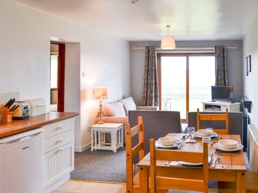 Dining and kitchen areas and adjacent living space | Granary Cottage - Common House Farm, Melkridge