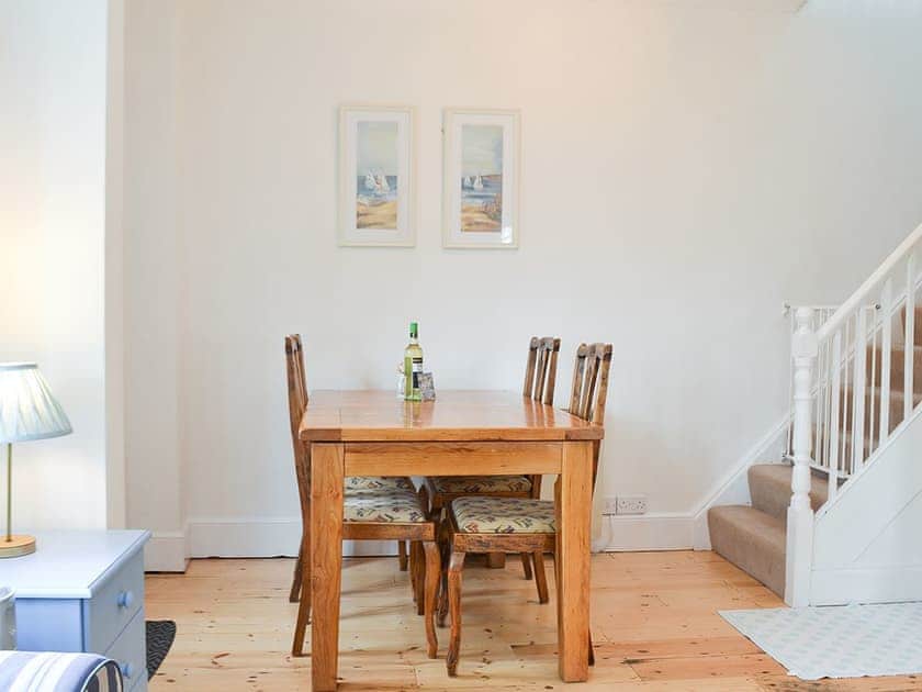 Modest dining area inthe wooden floored living area | Beech Cottage, St Lawrence, near Ventnor