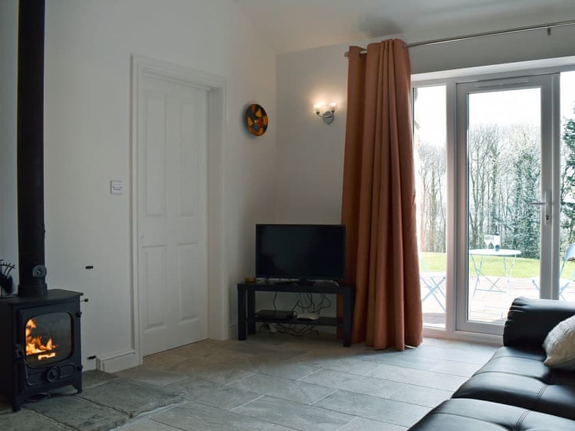 Lovely living area with patio doors leading to patio | Park Hill Barn, Woolaston, near Chepstow
