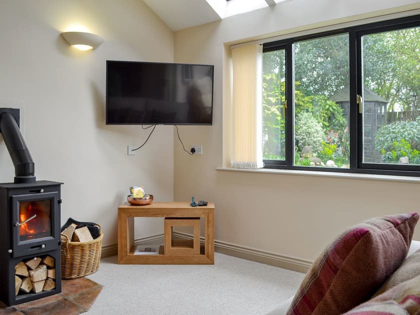 Charming living room with wood burner | End Cottage, Tibthorpe, near Driffield 