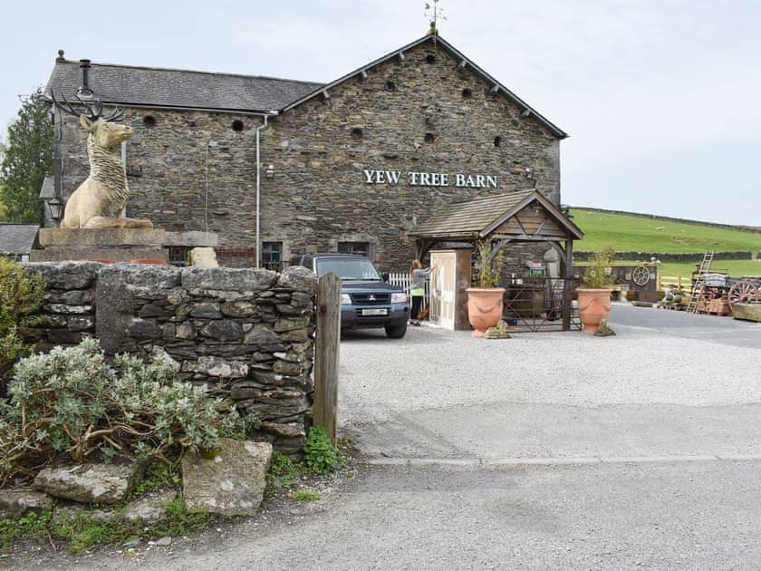 Main entrance from the road to the holiday cottage which goes past this antiques and reclamation barn with cafe | Yew Tree Farm, Low Newton