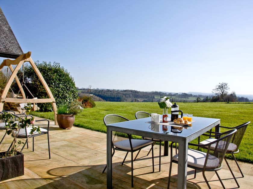 Patio with a range of outdoor furniture | Number 6 Quantock Lodge, Cricket St Thomas, near Chard
