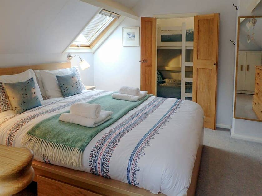 Double bedroom leading through to bunk bedroom | Heale Cottage, Littleham, near Bideford