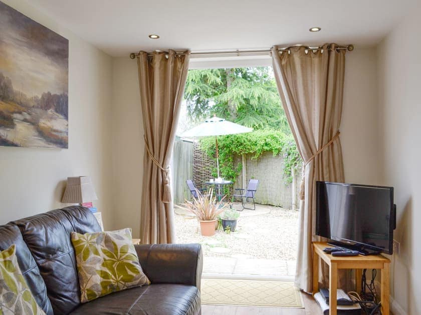 Cosy living area with doors to the patio area | Fieldview Cottage, Bruisyard, near Framlingham