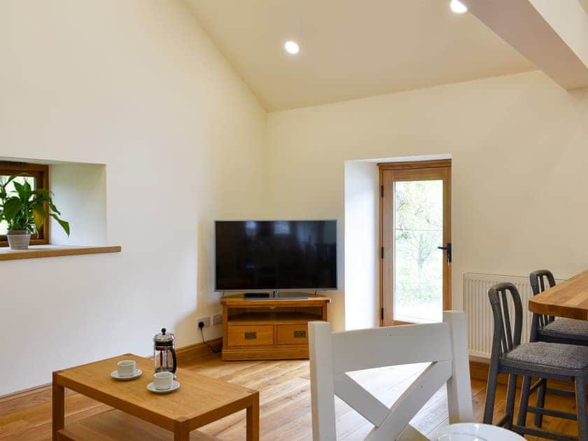 Open plan living space with wooden floor | Lake View Farm, Watermillock, near Penrith