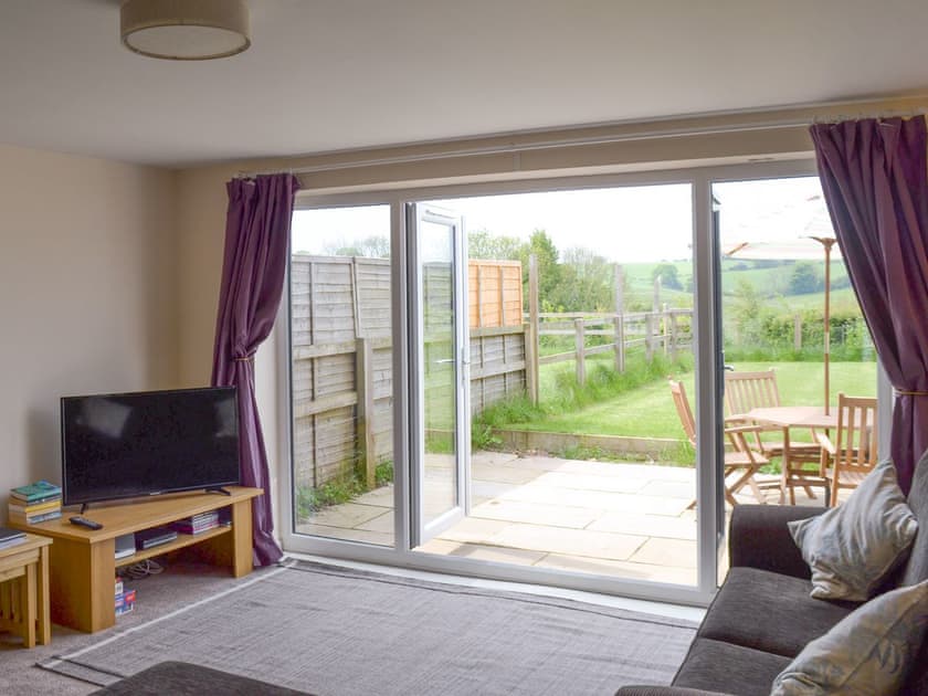Living area with French doors to the garden | Louisa’s Cottage, Priors Dean, near Petersfield