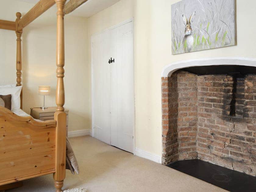 Heritage fireplace within the four poster bedroom | Belfrey House, York