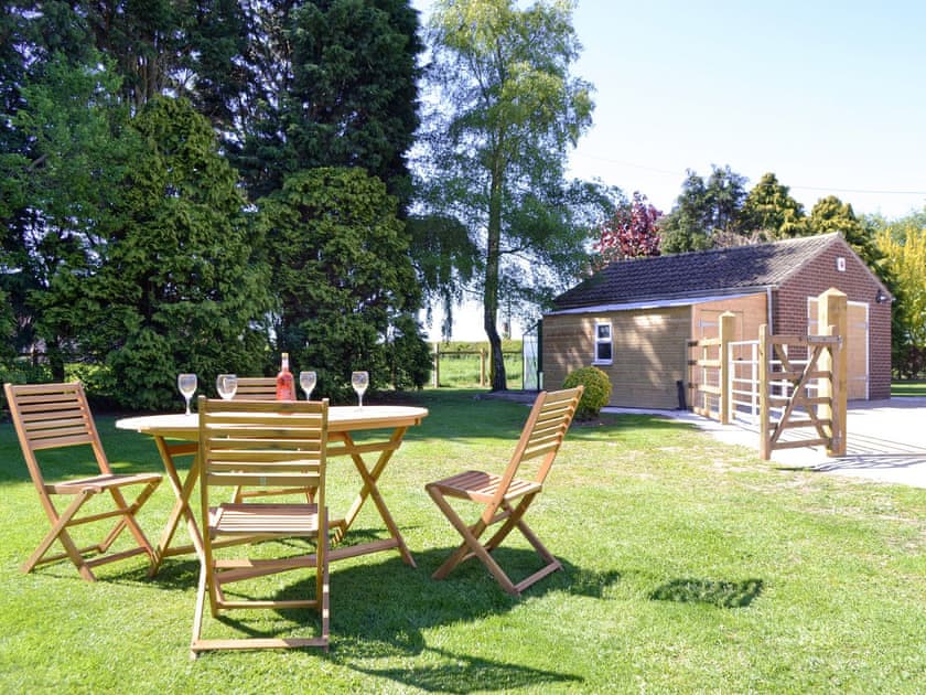 Lawned garden with outdoor furniture | Wayside Cottage, North Frodingham, near Driffield