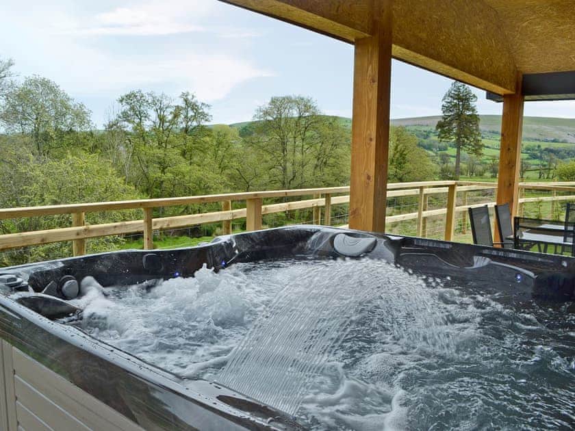 Inviting hot tub with amazing views | River Lodge - Bryncoch Holidays, Hundred House, near Builth Wells