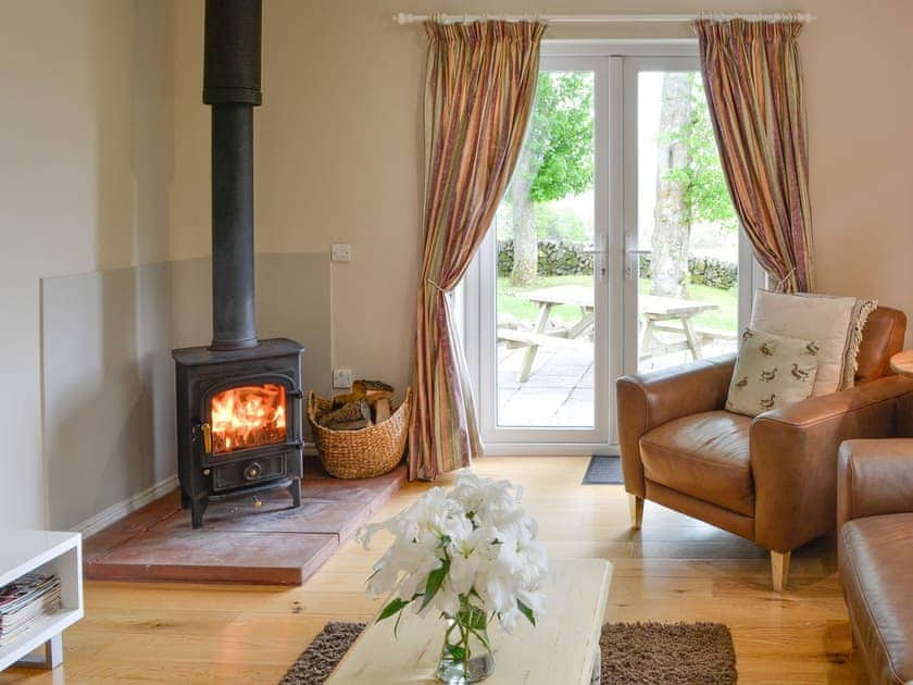 Warm and cosy living room with woodburner | Cleughbrae Cottage, Dalry, near Castle Douglas