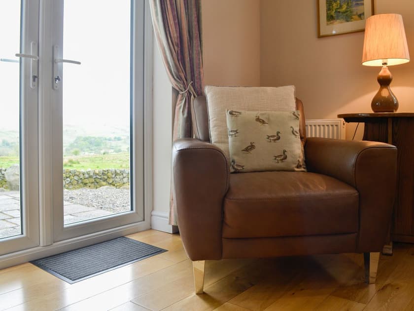 Welcoming living room with patio doors to the garden | Cleughbrae Cottage, Dalry, near Castle Douglas