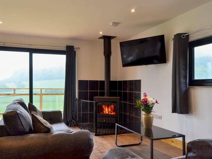 Living area with wood burner | Offa’s Dyke Lodge - Acre Luxury Lodges, Stanner, near Kington