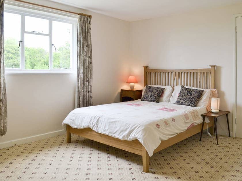Spacious double bedroom with cot | Tutchenor Farmhouse, Patchacott, near Beaworthy