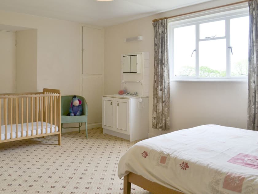 Family bedroom with double bed and cot | Tutchenor Farmhouse, Patchacott, near Beaworthy