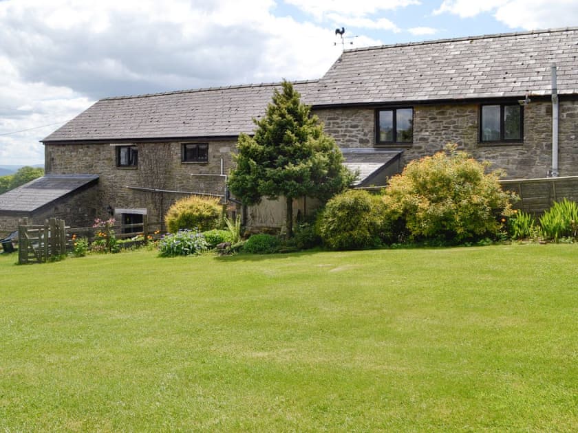 Lawned garden at rear of cottage | Woodland View - Cefncoedbach Farm, Sarnau, near Brecon
