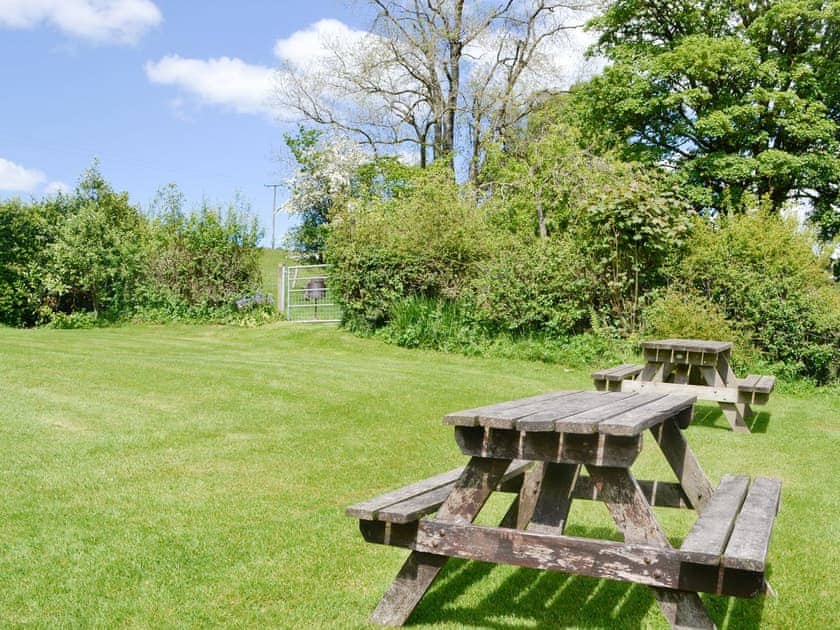 Enclosed garden area with outdoor seating | Woodland View - Cefncoedbach Farm, Sarnau, near Brecon