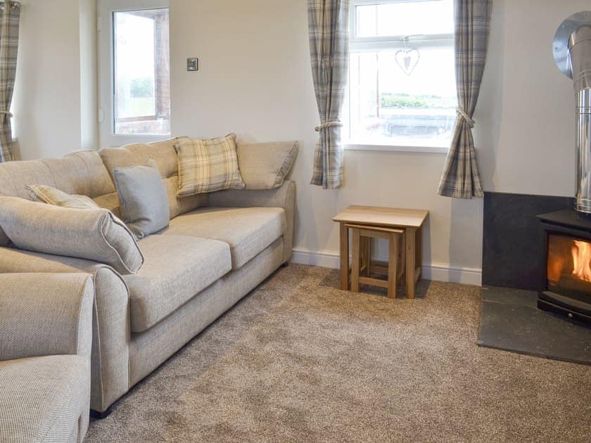 Comfortable living area with wood burner | Granary Cottage - Metlands Farm Holidays, Bempton, near Bridlington