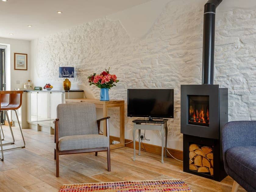 Warming wood burner within the living area | Wrens Perch, Brixham