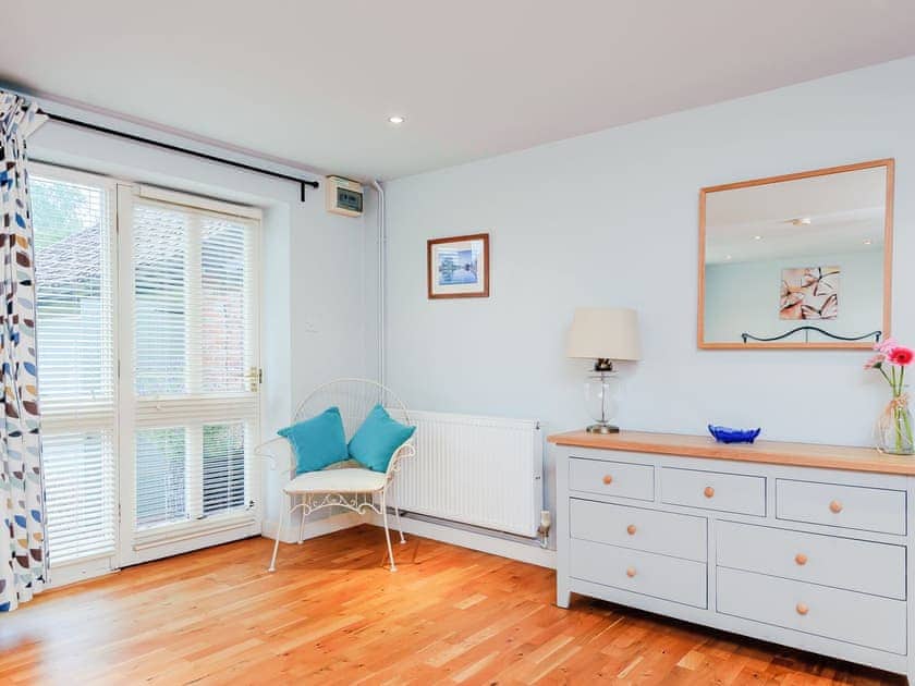 Pretty bedroom with double doors to the garden | Coachman’s Cottage - Yaxley Manor Cottages, Yaxley near Eye