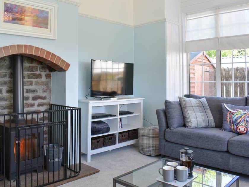 Comfortable living room with wood burner | 1 Hamilton Terrace, Lamlash, Isle of Arran