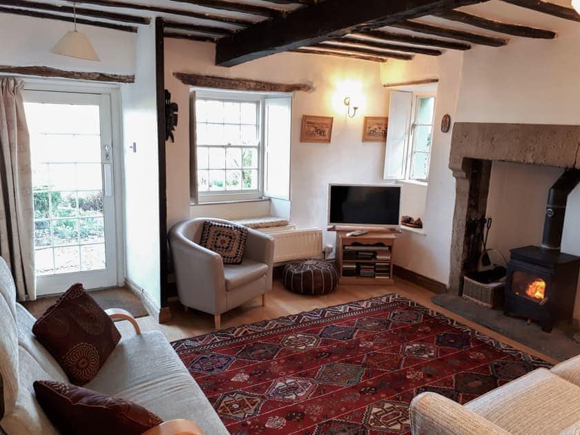 Living room with wood burner | Chapel Cottage, Helton