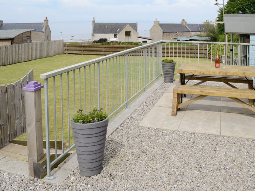 Paved patio area with outdoor furniture | Sunset Cottage, Portmahomack, near Tain