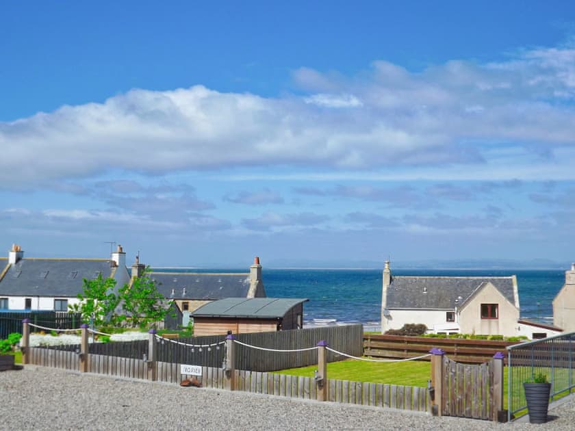 View over garden towards the coast | Sunset Cottage, Portmahomack, near Tain