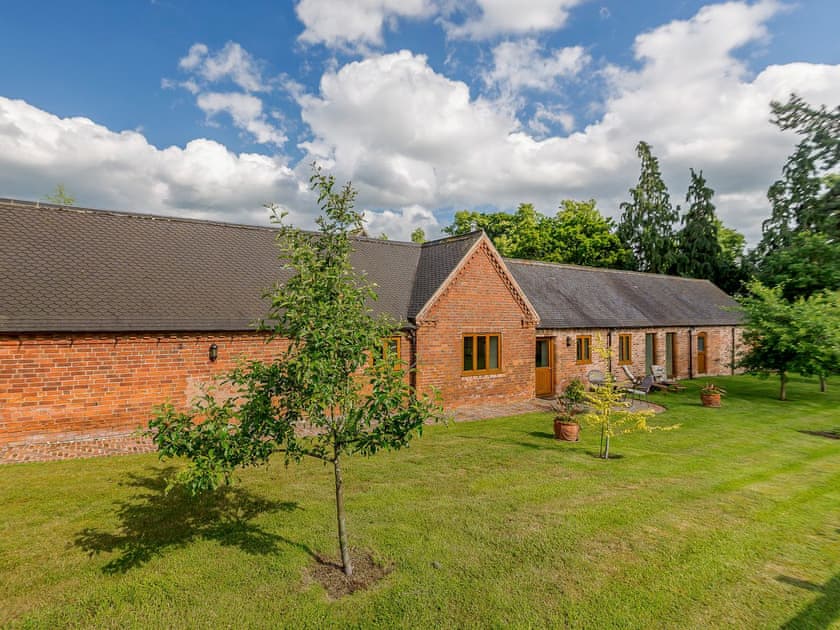 Large lawned garden with patio | Courtyard Lodge, Rufford, near Newark