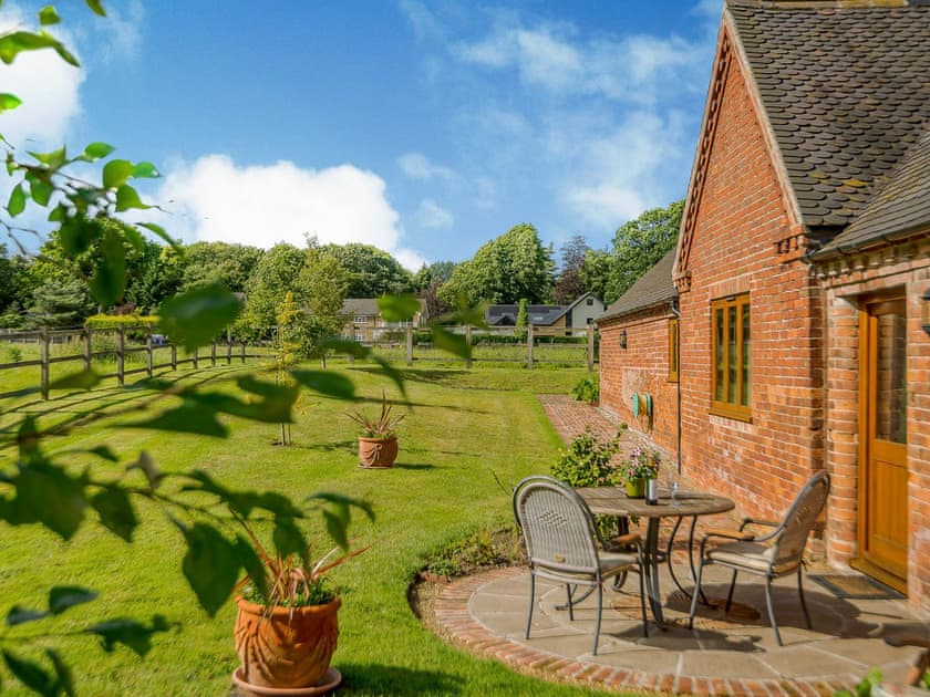 Large lawned garden with patio | Courtyard Lodge, Rufford, near Newark