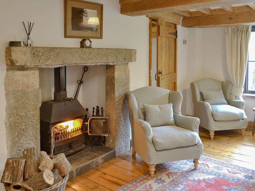 Warm and welcoming living room with wood burner in feature fireplace	 | Warmhill Farmhouse, Hennock, near Bovey Tracey