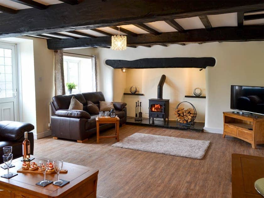 Spacious living area with a wood burner | Tyddyn Eli, Llangwm, near Corwen