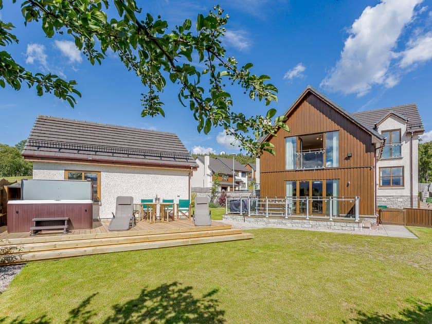  Enclosed lawned rear garden with sitting-out area | The Lookout, Aviemore