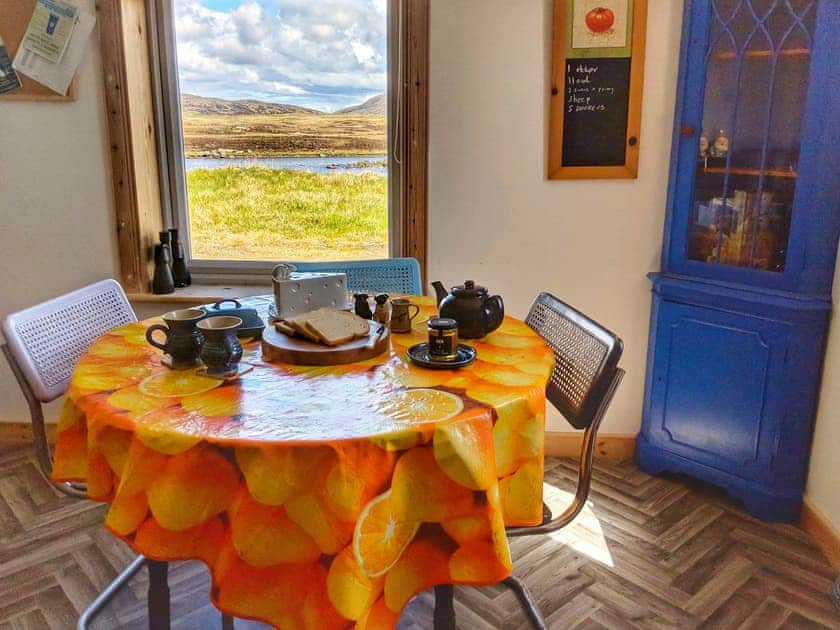 Dining area with lochside views | Altabrug, Stoneybridge, Isle of South Uist