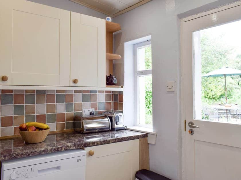 Well-equipped kitchen with access to patio area | Kirkview Cottage, Upper Largo, near Leven
