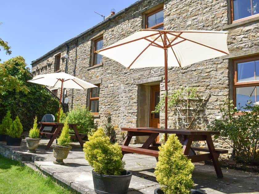 Paved patio area with outdoor furniture | Ingleby Lodge, Askrigg, near Hawes