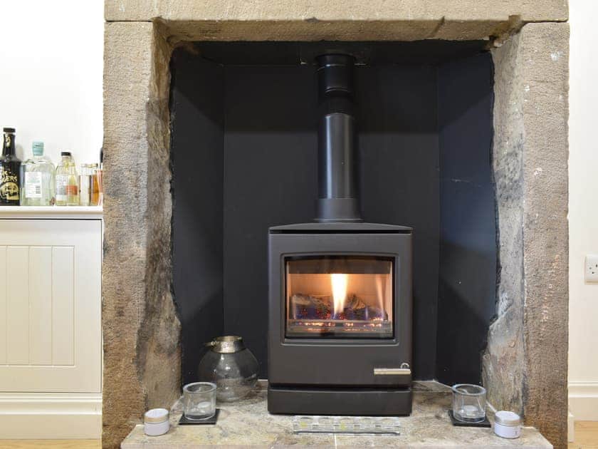 Warming wood-burner style gas fire | Easter Cottage, Bamford, near Hope Valley
