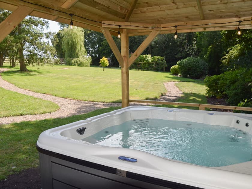 Six person hot tub set in a beautiful garden | Twisly North Lodge, Catsfield, near Battle