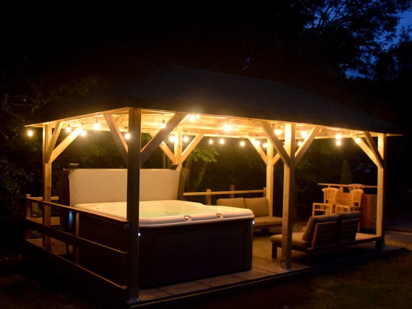 Outdoor socialising area by night | Twisly North Lodge, Catsfield, near Battle
