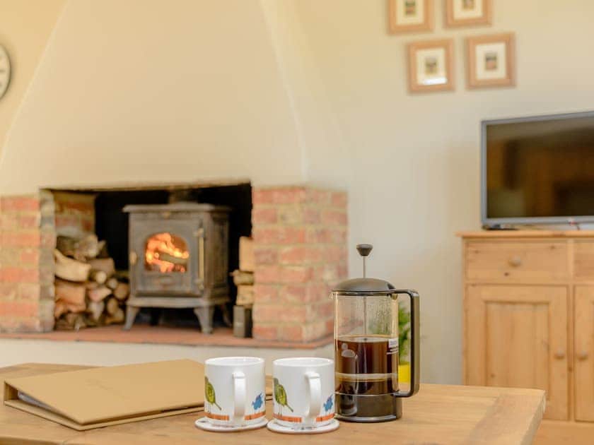 Cosy living area with wood burner | Farm Cottage - Kingates Farm, Whitwell, near Ventnor
