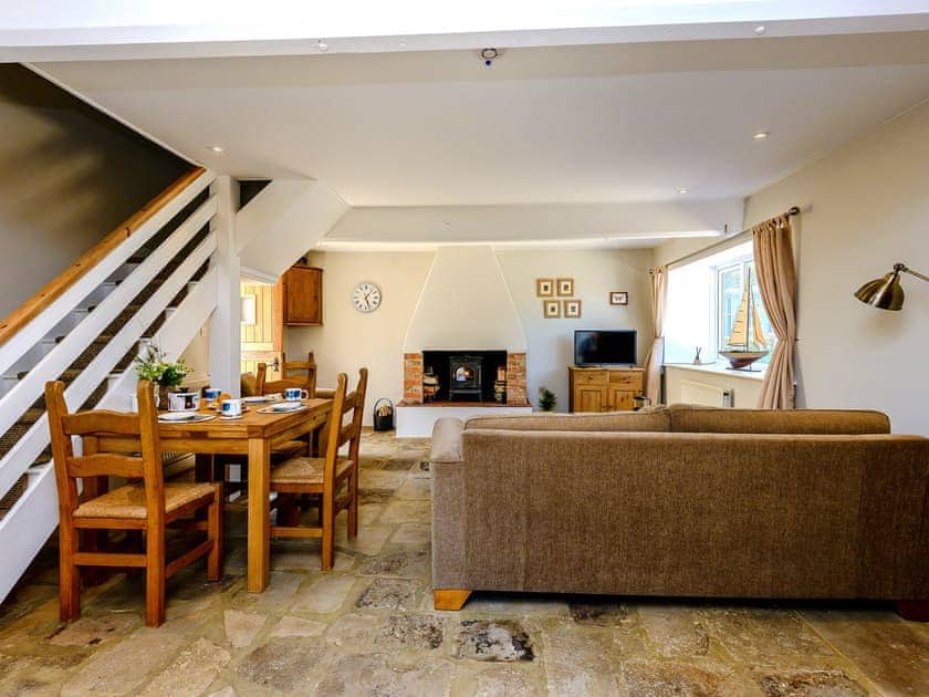 Open plan living space with beams and flagstone floor | Farm Cottage - Kingates Farm, Whitwell, near Ventnor