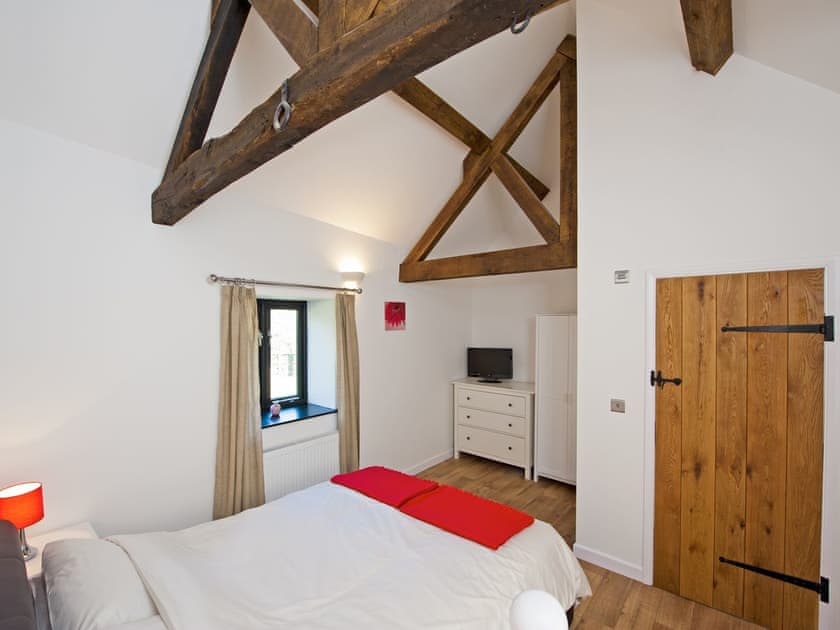 Comfortable double bedroom with exposed wood beams | East Barns - Fernhill Farms, Ryde