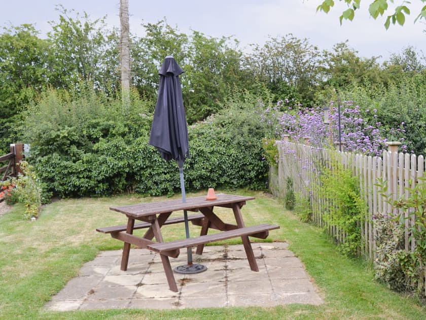 Paved patio area with outdoor furniture | Iris Apartment, Daisy Apartment - Chapelfield Apartments, Stalham
